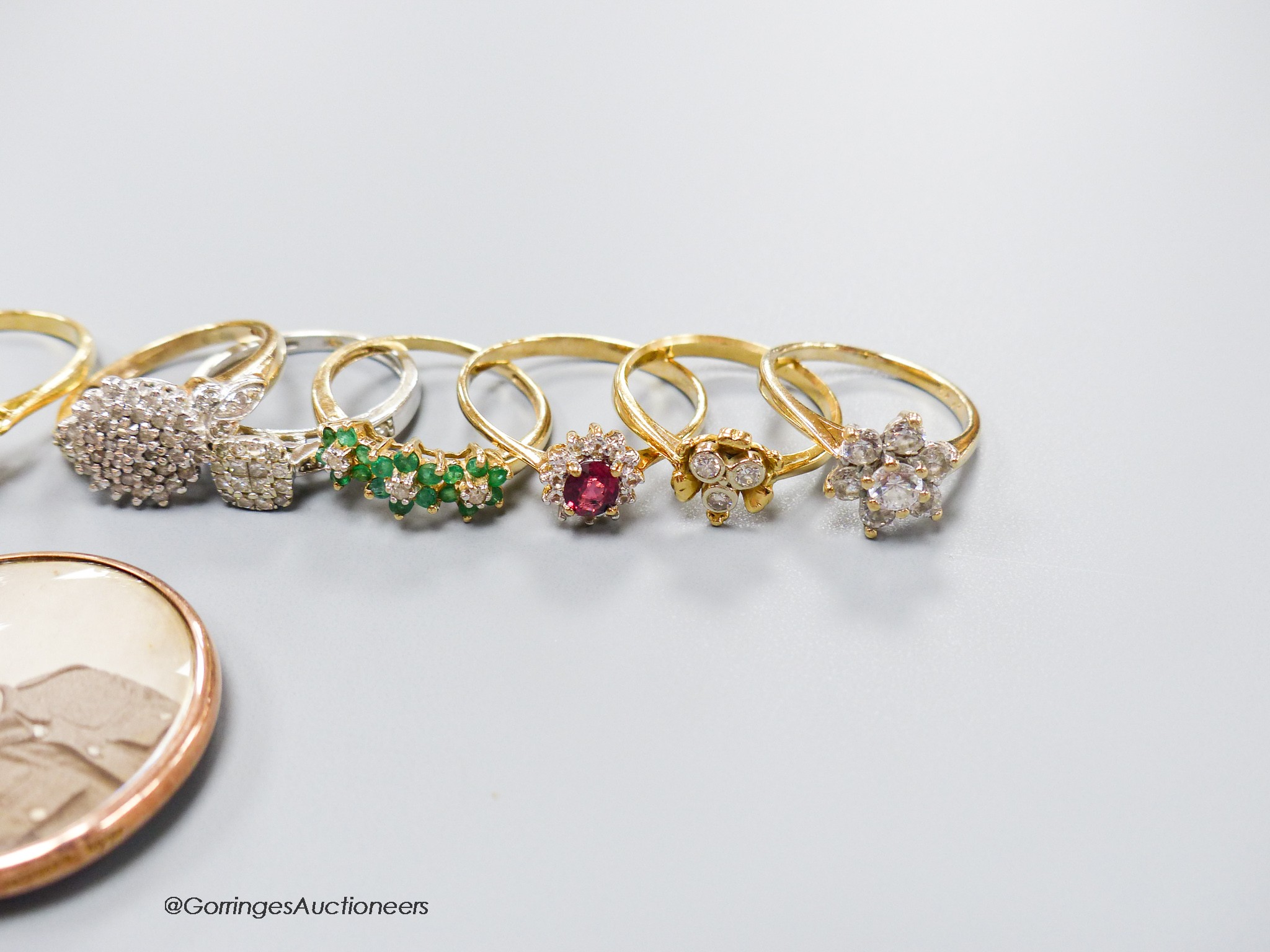 A modern 18ct gold, sapphire and diamond oval cluster ring and an 18ct gold and three stone diamond cluster ring, gross 6.1 grams, six assorted modern 9ct gold and gems set rings, gross 13 grams and three 9ct pendants, g